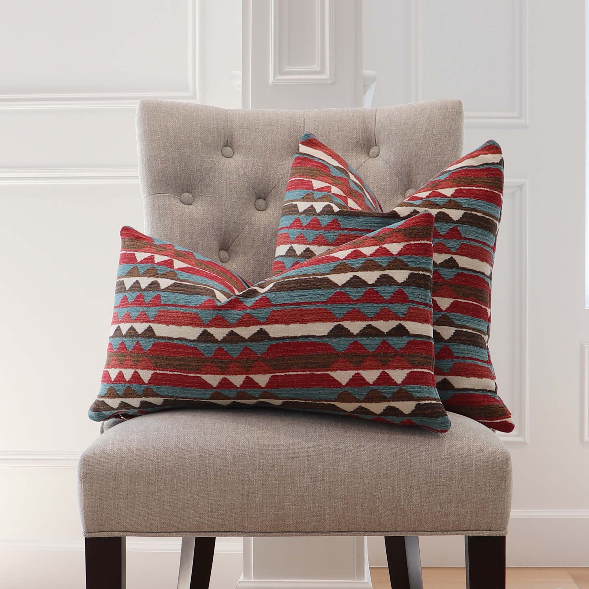 https://www.chloeandolive.com/cdn/shop/files/Thibaut_InsideOut_Performance_Fabric_Saranac_Redwood_Red_Turquoise_Blue_Woven_Ikat_Kilim_Patttern_Designer_Luxury_Throw_Pillow_Cover_on_Chair_In_Home_Decor_5000x.jpg?v=1692676037