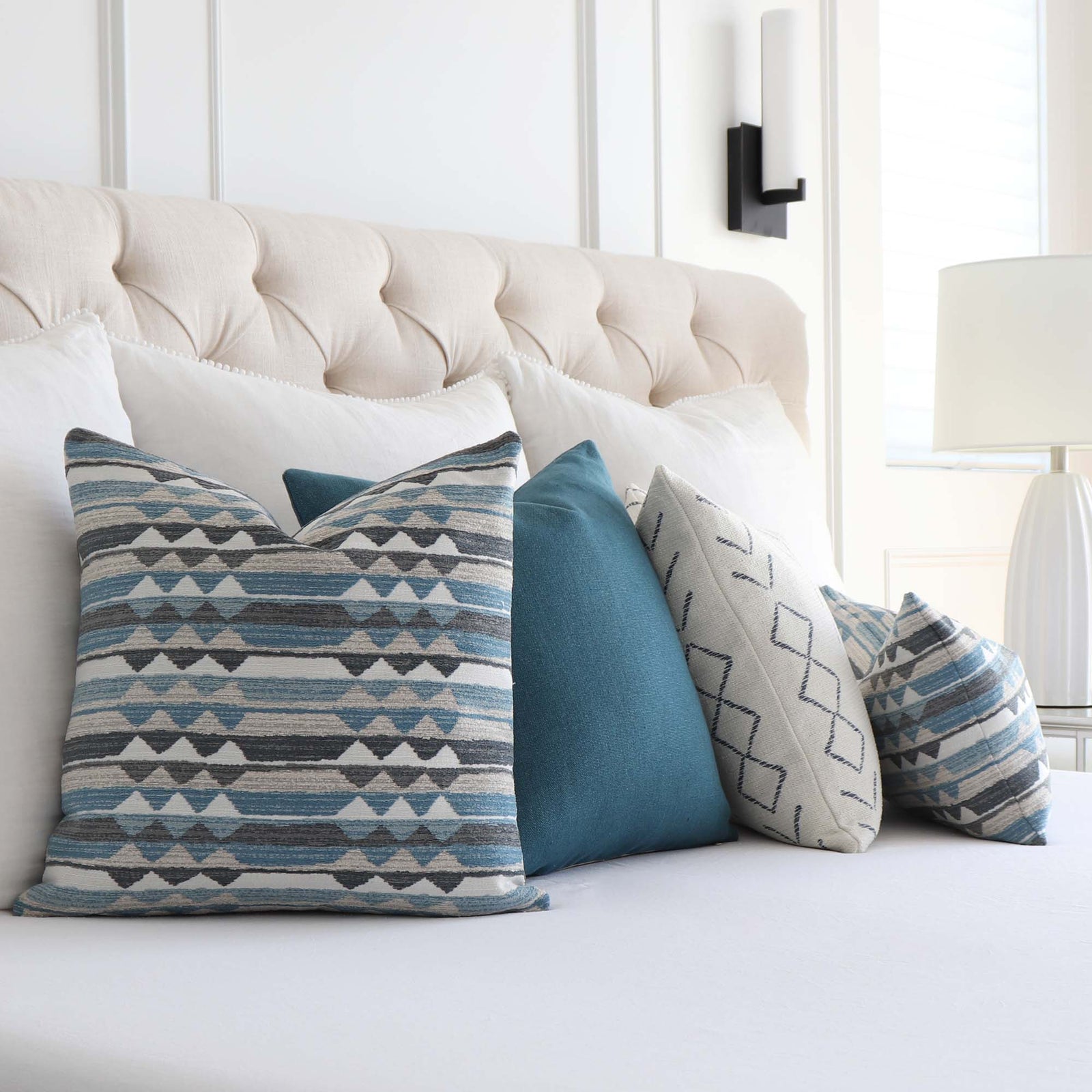 https://www.chloeandolive.com/cdn/shop/files/Thibaut_InsideOut_Performance_Fabric_Saranac_Waterfall_Blue_Woven_Ikat_Kilim_Patttern_Designer_Luxury_Throw_Pillow_Cover_in_Bedroom_with_Matching_Throw_Pillows_1600x.jpg?v=1692677727