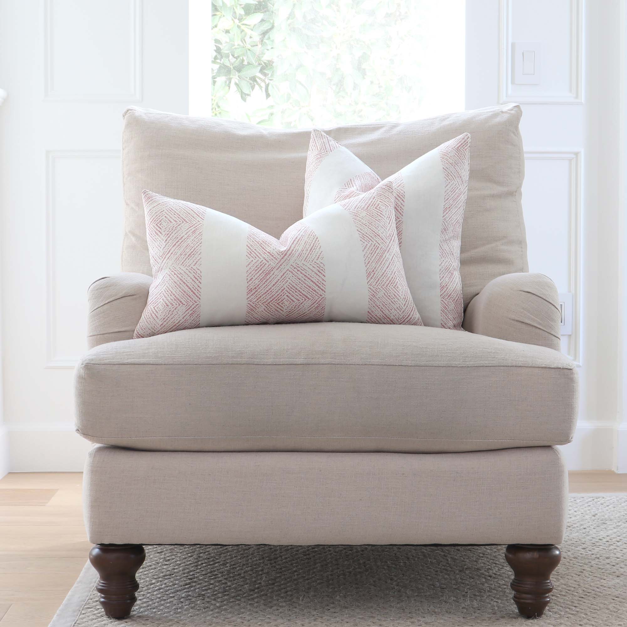 https://www.chloeandolive.com/cdn/shop/products/thibaut-clipperton-stripe-blush-pink-block-print-designer-luxury-throw-pillow-cover-on-accent-chair-in-living-room-decor_5000x.jpg?v=1645593535